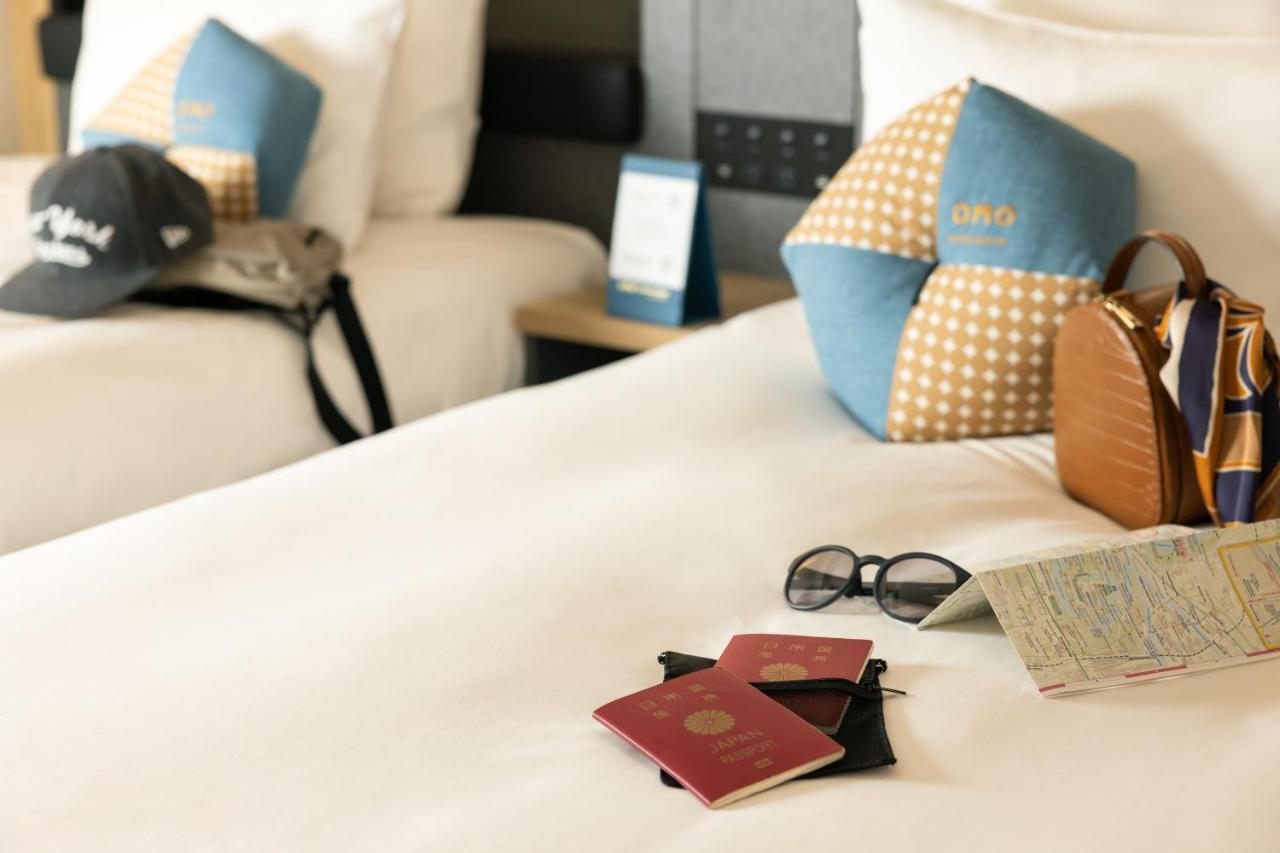 Omo Kansai Airport By Hoshino Resorts Izumisano Exterior photo A passport and a boarding pass on a bed